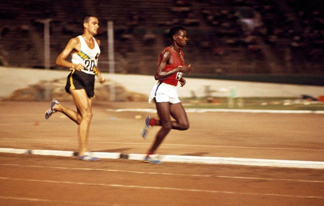 Gold medalist Naftali Temu of Kenya leads silver medalist Ron Clarke of Australia in the 6-mile event during the British Empire and Commonwealth Games in Kingston, Jamaica, on August 6, 1966. 