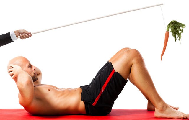 carrot held over a man working out.