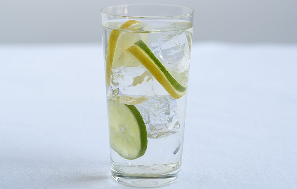drink up glass of water with lemon
