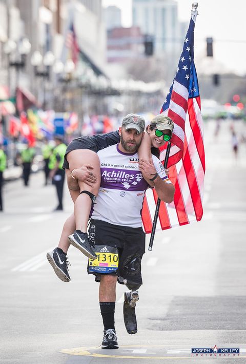 Earl Granville carrying his guide over the finish line of the Boston Marathon