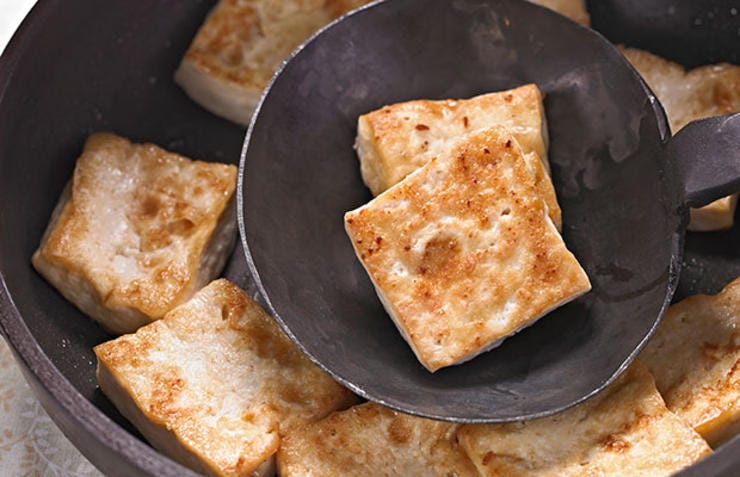 Tofu frying in a pan