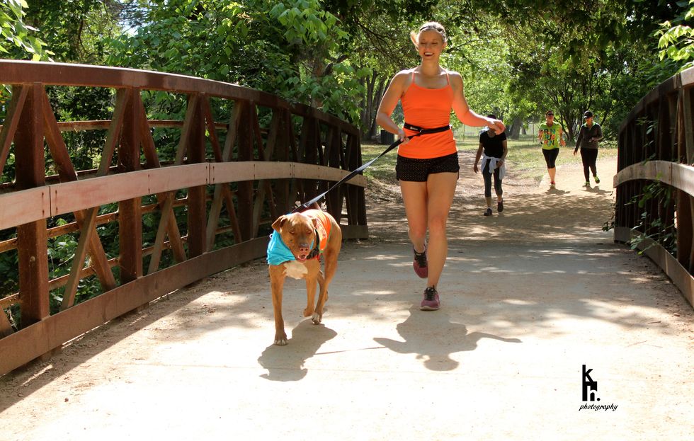 Mary Wasson runs with dog on bridge