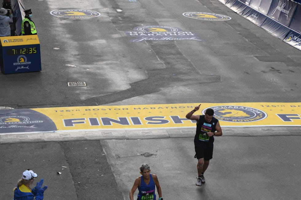 jon custodio crosses finish line boston marathon