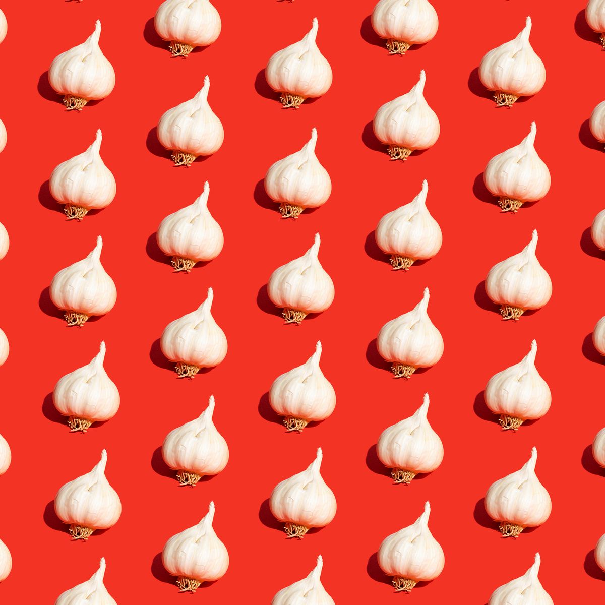 garlic bulbs on red background