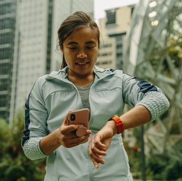 how to train for your first 10k how to train for your first 10k, woman reading watch