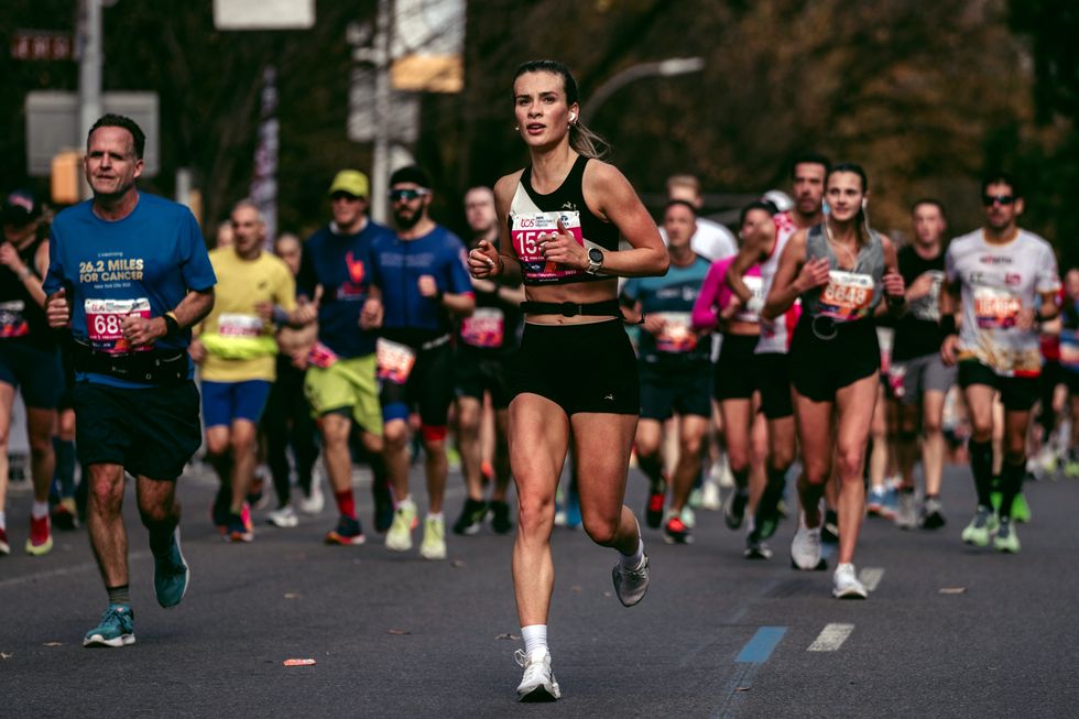a woman running the new york city marathon