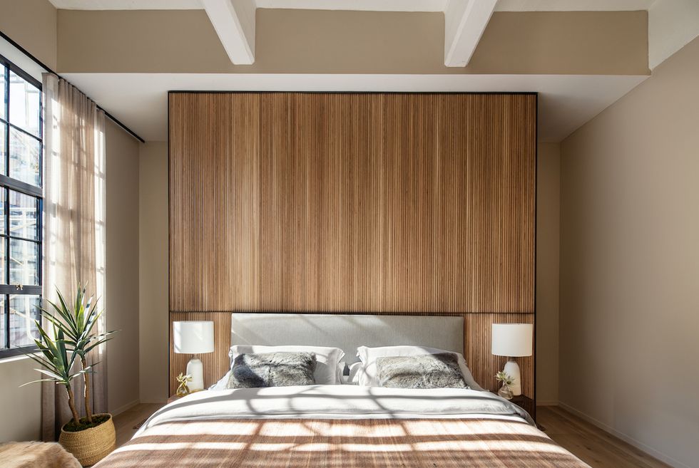 bedroom, wooden feature wall, gray headboard, white table lamps,