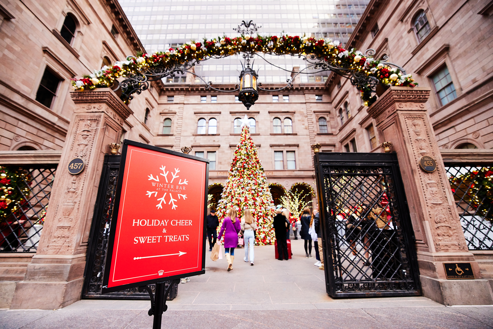 entrance to a holiday event featuring a large decorated tree