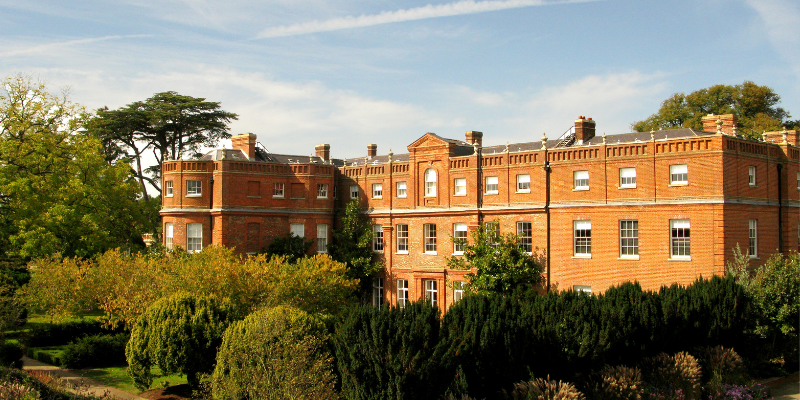 a large brick building with trees in front of it