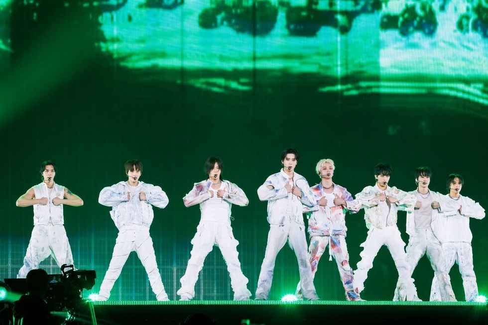 a group of men in white outfits