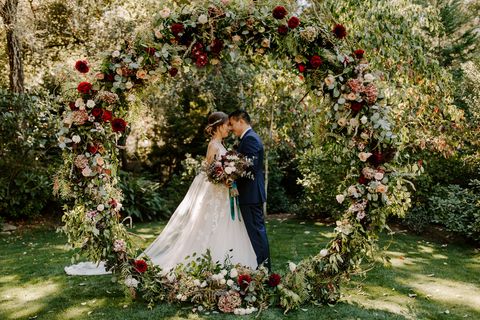 Photograph, Bride, Ceremony, Wedding dress, Wedding, Architecture, Dress, Flower Arranging, Arch, Garden roses, 