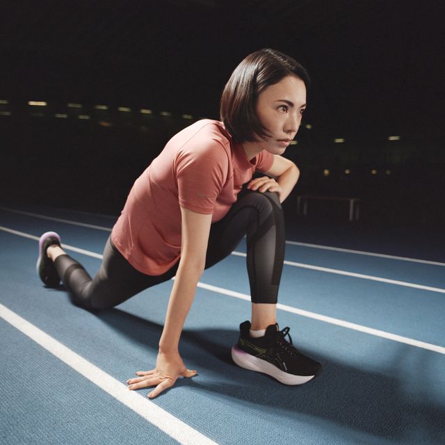 a woman stretching on a track