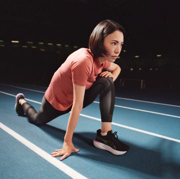 a woman stretching on a track