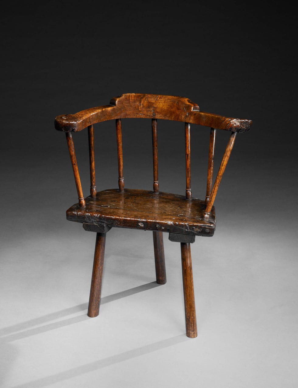 rare primitive windsor armchair with massive crested horseshoe armbow and turned spindles hewn and turned solid oak with rich patination welsh, carmarthenshire, c1780