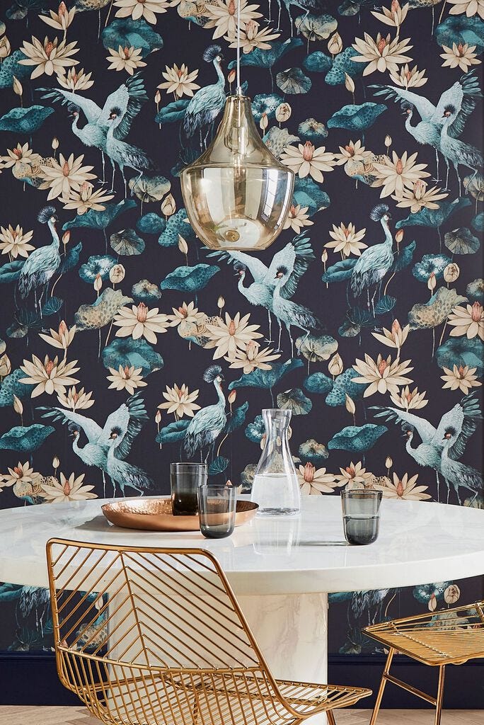 Interior space featuring a round dining table decorative wallpaper and modern furnishings interior space featuring a round dining table decorative wallpaper and modern furnishings