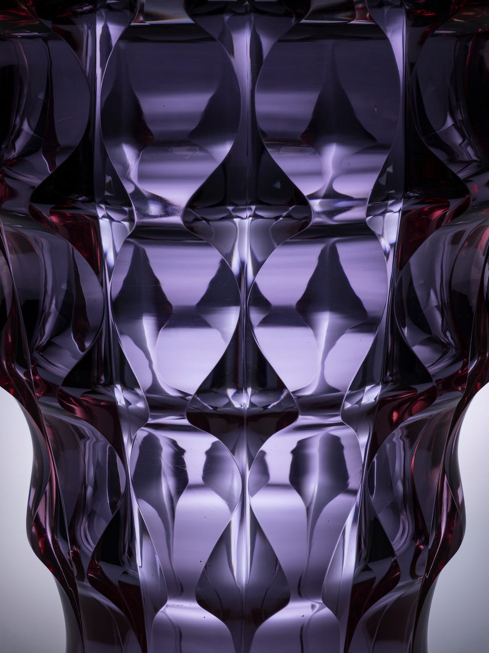 Abstract geometric vase with purple hues and reflective surfaces