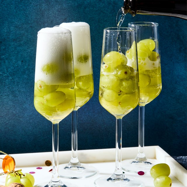 glasses of champagne filled with 12 green grapes