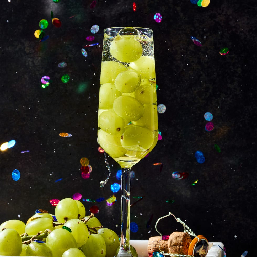 glasses of champagne filled with 12 green grapes