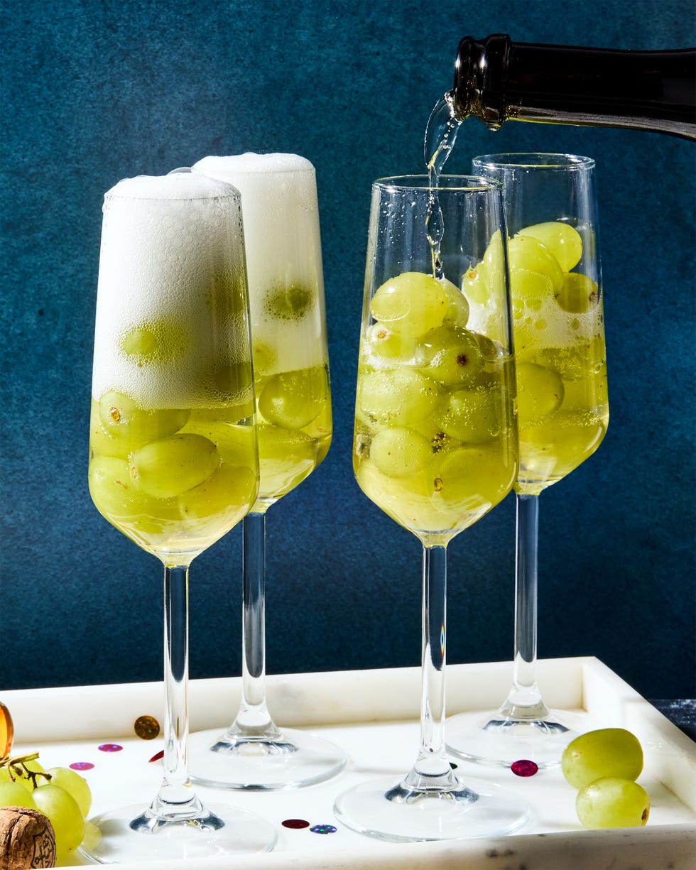 glasses of champagne filled with 12 green grapes