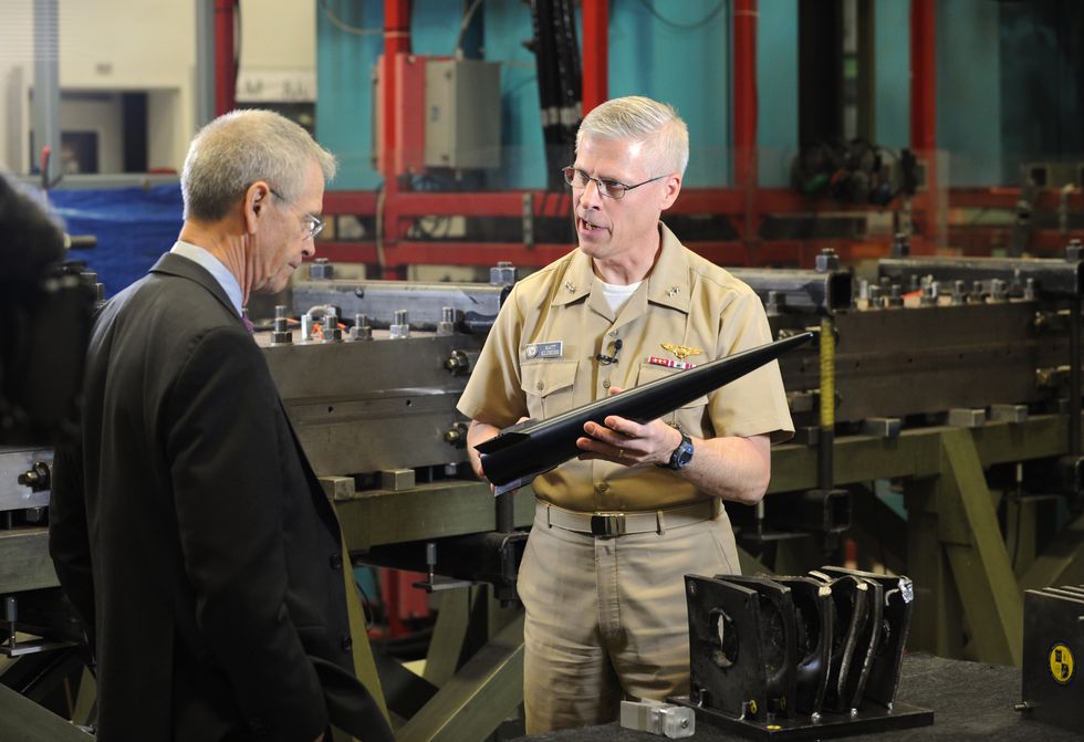 140404 n po203 041 washington april 4, 2014 rear adm matthew klunder, chief of naval research, shows off a hypervelocity projectile hvp to cbs news reporter david martin during an interview held at the naval research laboratory's materials testing facility the hvp is a next generation, common, low drag, guided projectile capable of completing multiple missions for gun systems such as the navy 5 inch, 155 mm, and future railguns us navy photo by john f williamsreleased