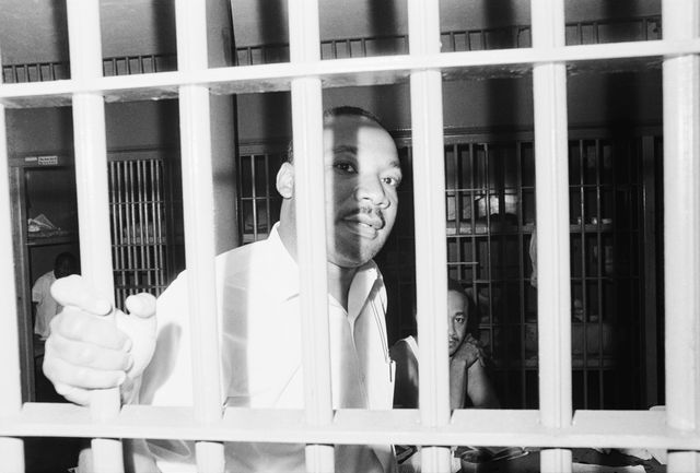 Dr. Martin Luther King peers between the bars of his jail cell at the St. John's County Jail