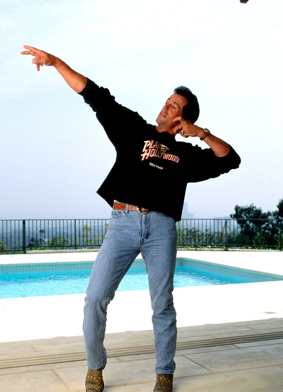beverly hills, ca may  16, 1991 sylvester stallone beside the pool in his  beverly hills home celebrating the opening of the chain of restaurants called planet hollywood may 16, 1991, beverly hills, california photo by paul harrisgetty images