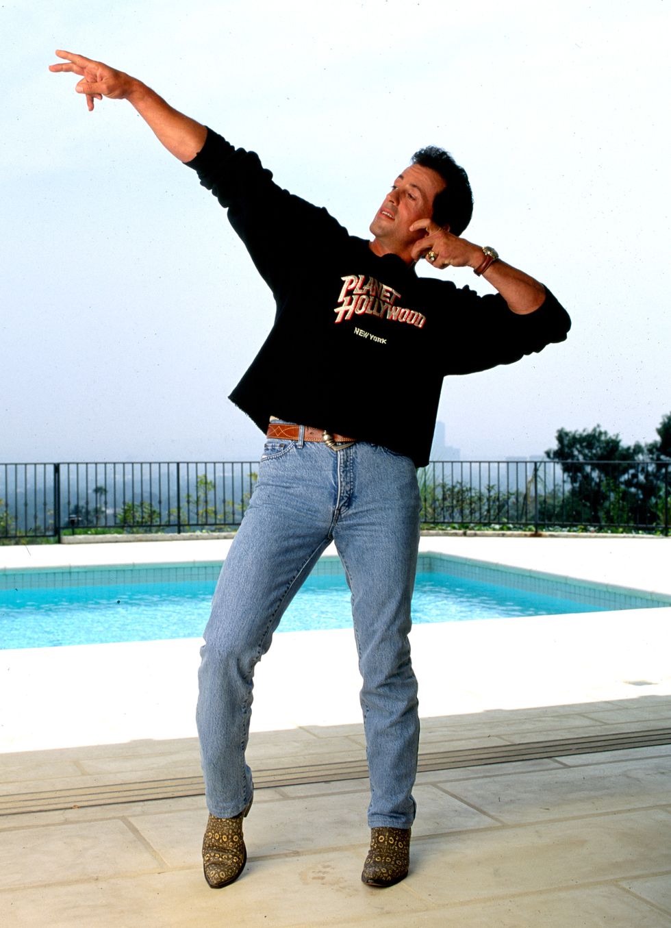 beverly hills, ca may  16, 1991 sylvester stallone beside the pool in his  beverly hills home celebrating the opening of the chain of restaurants called planet hollywood may 16, 1991, beverly hills, california photo by paul harrisgetty images