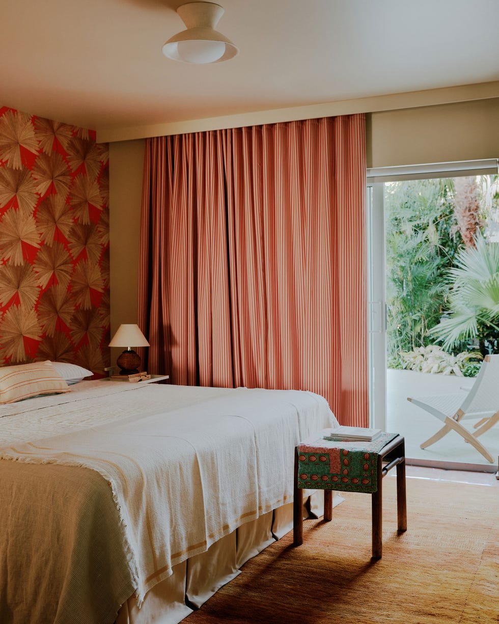 general assembly key west florida house key west guest bedroom with red curtains similarly red wallpaper and a view towards the outside
