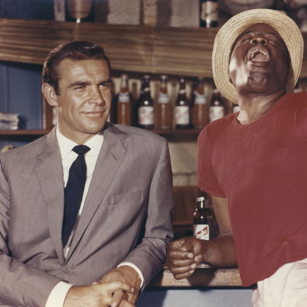 dr no 1962 sean connery as james bond 007 with john kitzmiller as quarrel standing by bar in the bahamas photo by screen archivesgetty images