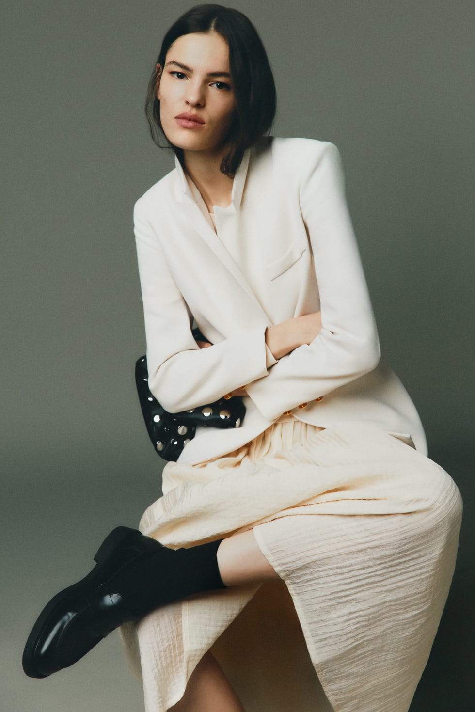 model seated in a fashionforward outfit