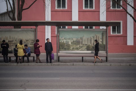 Op een foto die op maandag 10 april 2017 werd genomen wachten passagiers bij een bushalte in Pyongyang