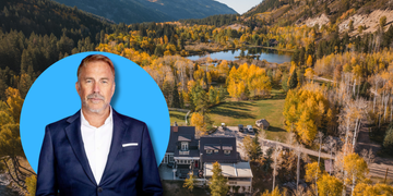 aerial landscape with vibrant fall foliage and a man in a suit on the side