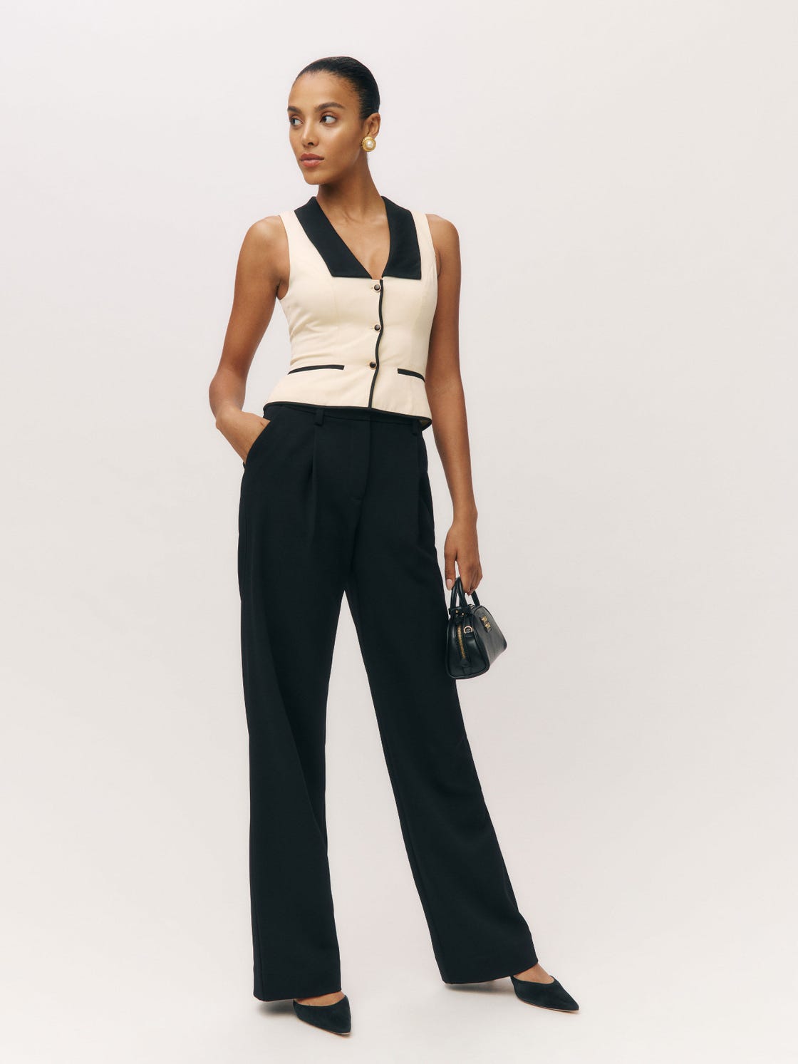 fashionable outfit featuring a sleeveless top and tailored pants