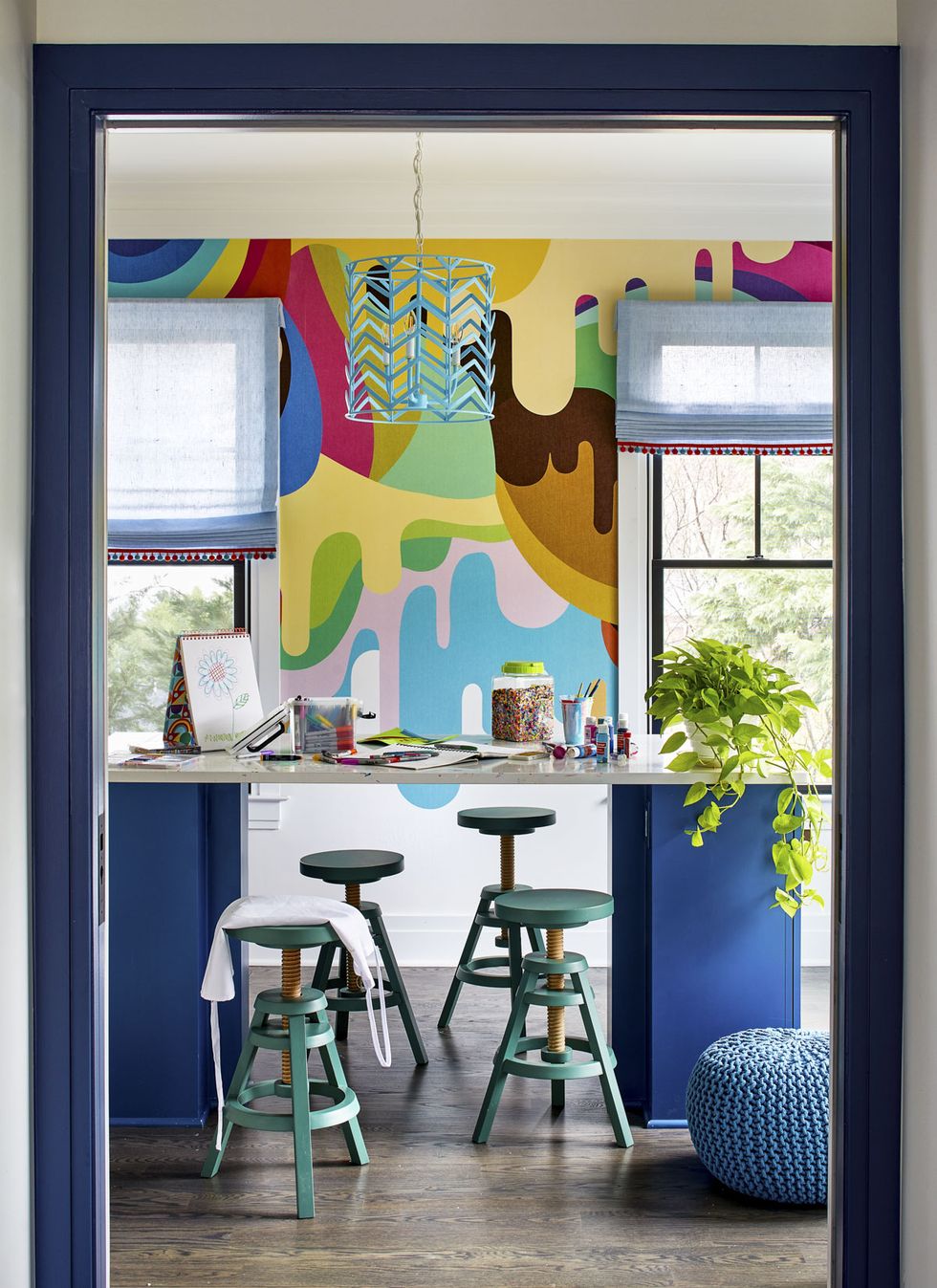kid's playroom with stools and art supplies on a high table