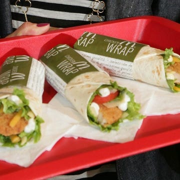 three chicken wraps on a red tray three chicken wraps on a red tray