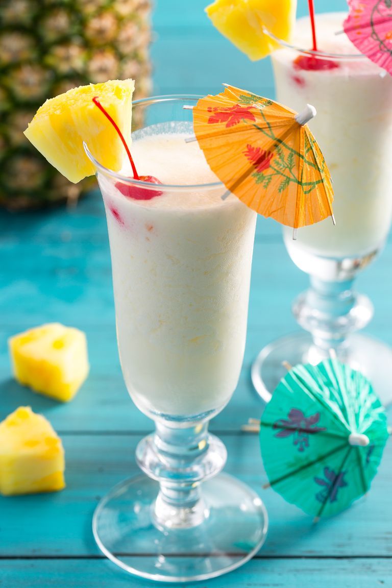 pina colada with cocktail umbrella and a slice of pineapple on the rim