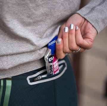 marathon runner putting gel in pocket marathon runner putting gel in pocket