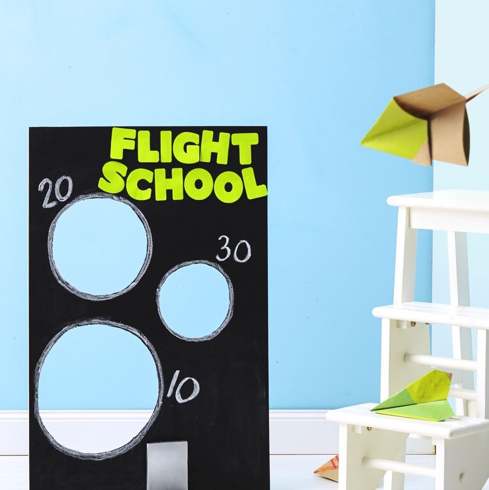 a homemade "flight school" with paper airplanes and targets