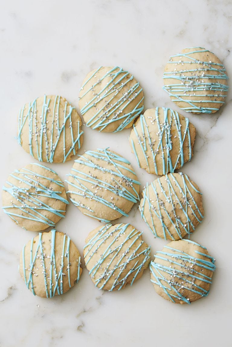 lemon ricotta cookies with blue icing drizzled on top