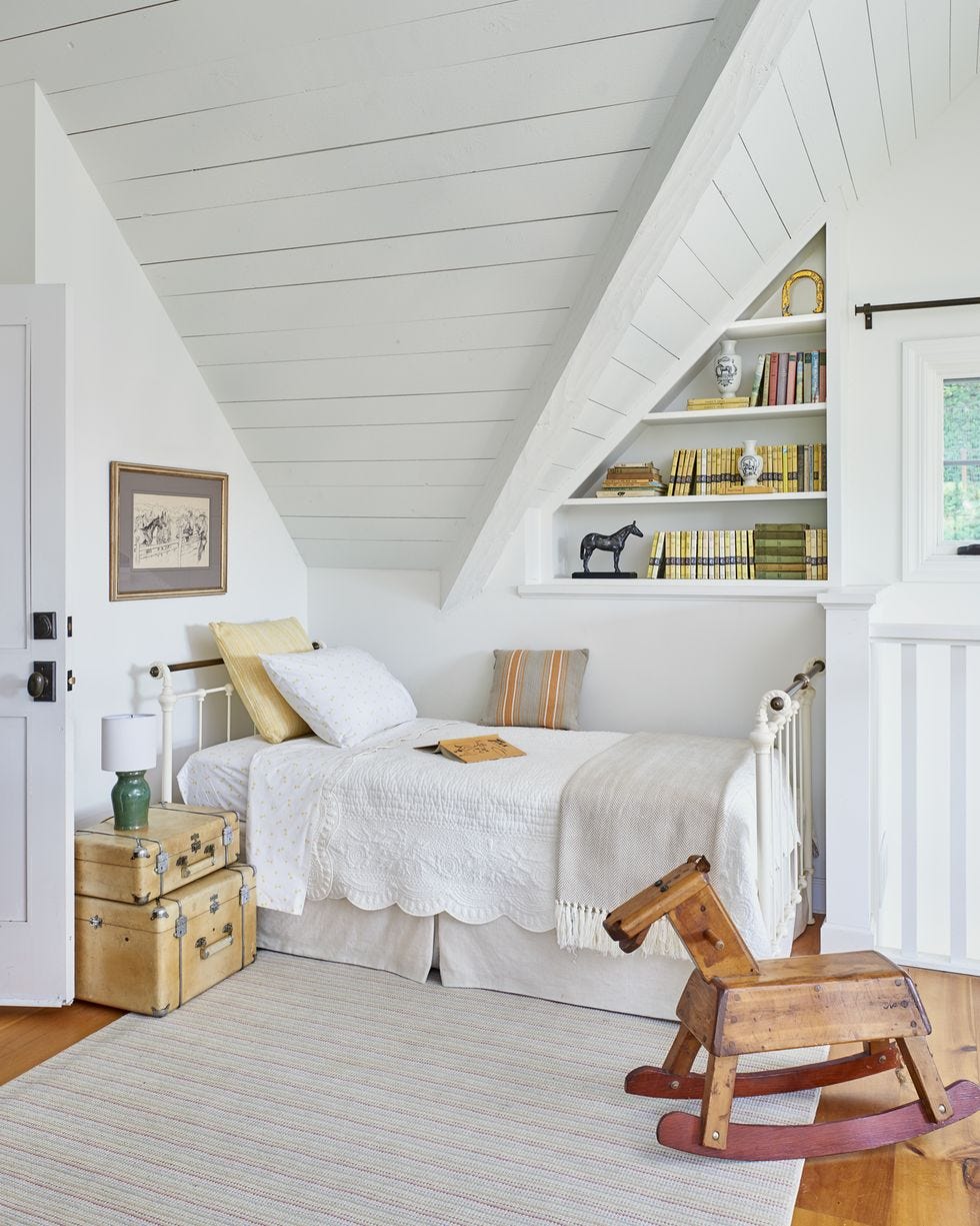 a bedroom with a white bed and white walls