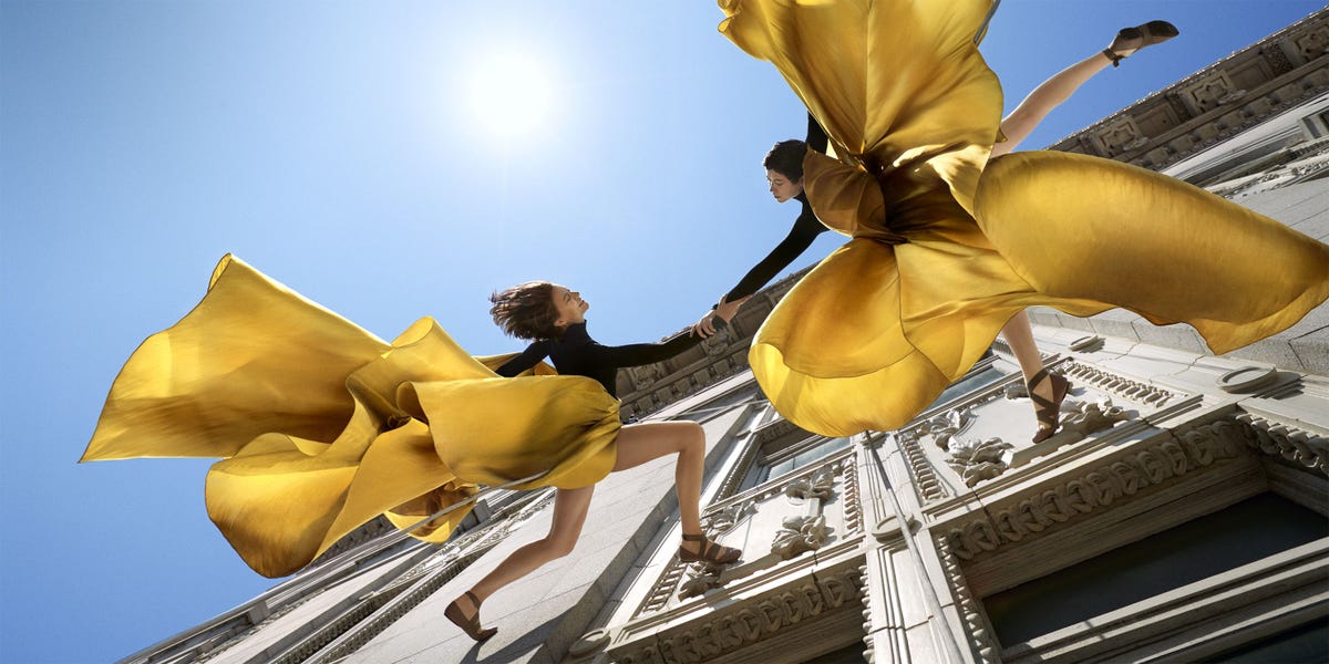 Yellow, Art, Fictional character, Sun, Sculpture, Angel, Wing, Lens flare, Costume, Supernatural creature, 