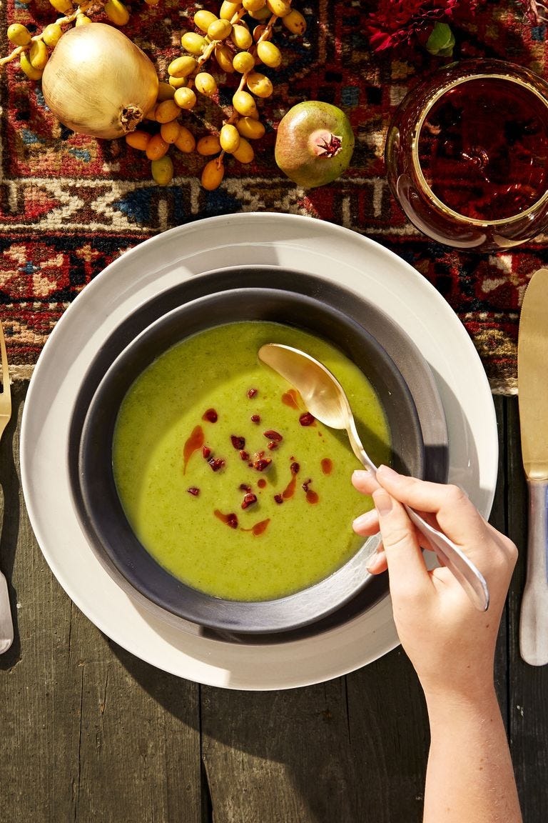 green potato kale soup with crispy chorizo in a bowl