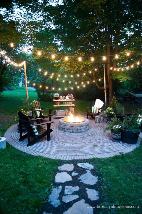 outdoor backyard fire pit idea with bistro lights