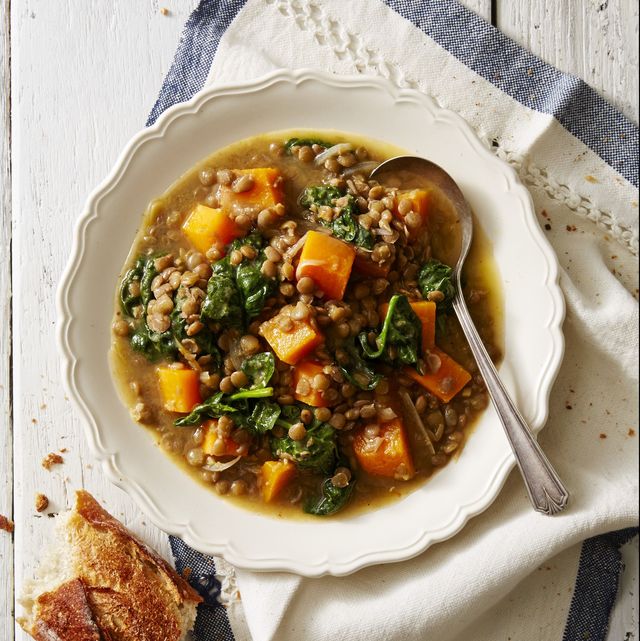butternut squash, lentils, and spinach in a white bowl