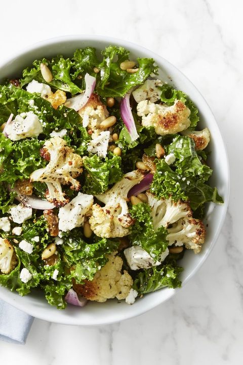 kale and roasted cauliflower salad in a white bowl