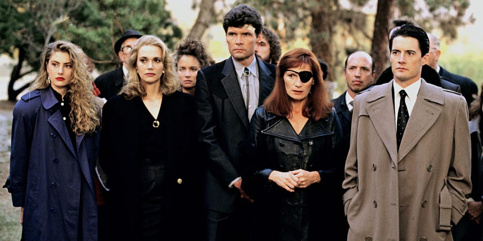 group of people dressed in formal attire outdoors