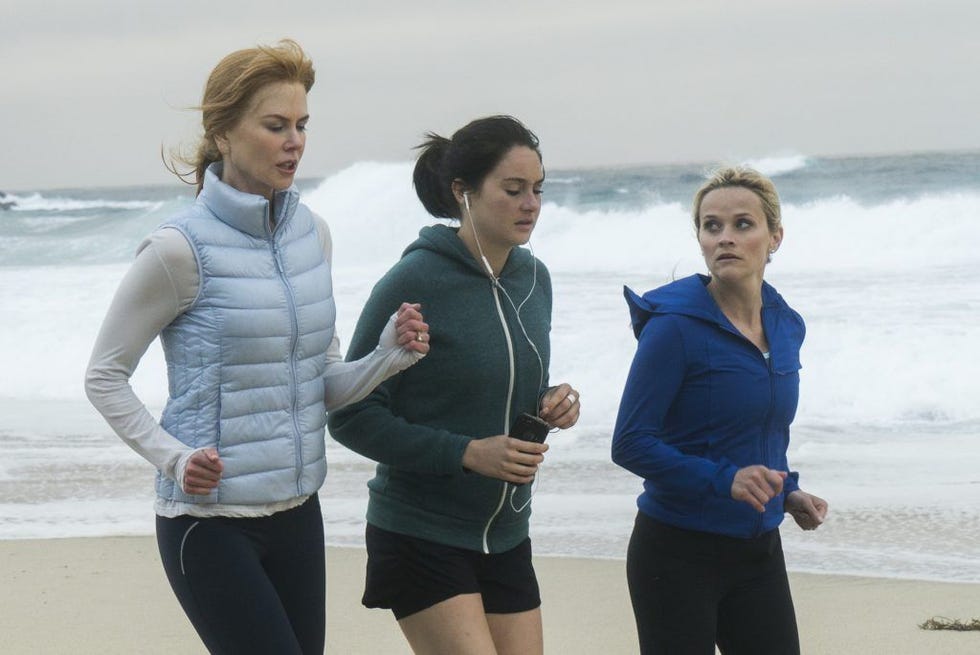 three women jogging along a beach