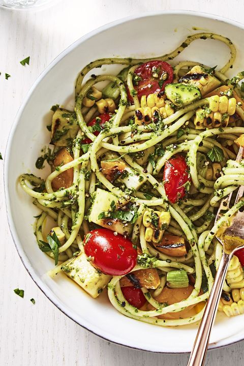 katie lee's summer pesto pasta in a white bowl with fork