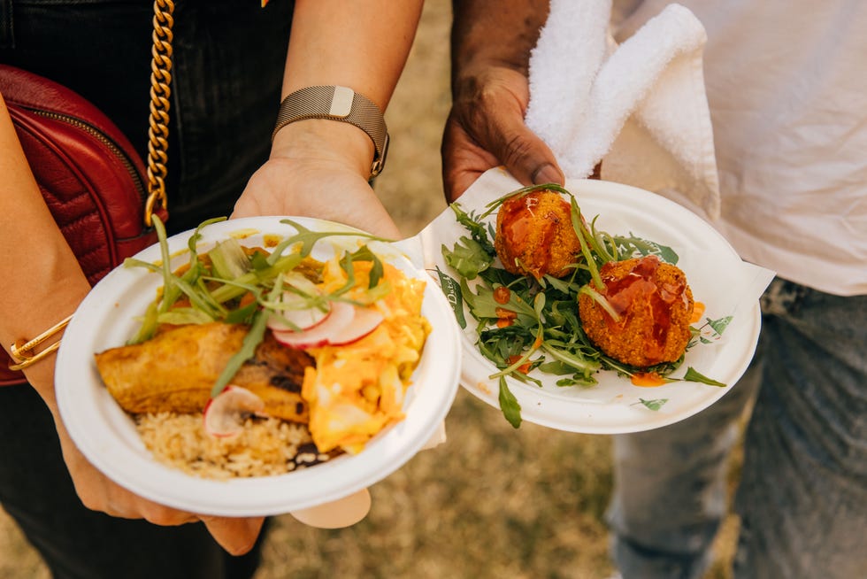 a couple of people holding plates of food