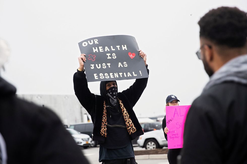 christian smalls holds a sign at amazon building during the outbreak of the coronavirus disease covid 19, in the staten island borough of new york city, us, march 30, 2020 reutersjeenah moon newscom tagid rtrleleven933794jpg photo via newscom